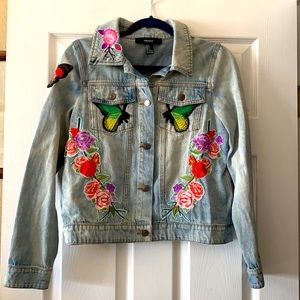 FOREVER 21 light wash jean jacket with sewn on patches